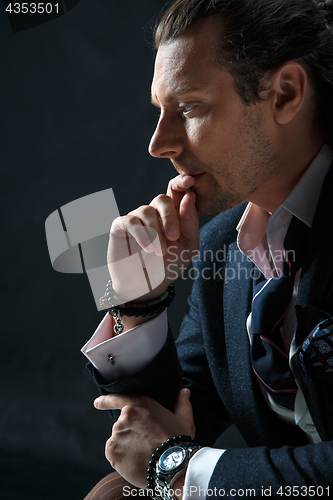 Image of Businessman sitting on an armchair