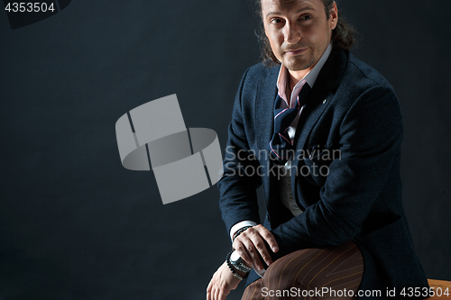 Image of Businessman sitting on an armchair