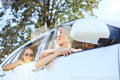 Image of The young women in the car smiling