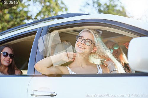 Image of The young women in the car smiling