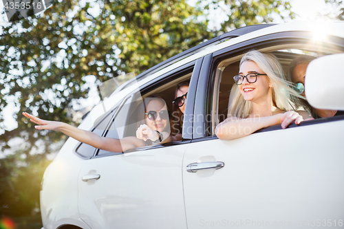 Image of The young women in the car smiling