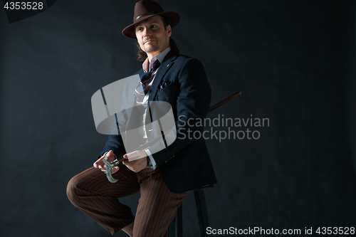 Image of Young man portrait with hat on gray studio background.