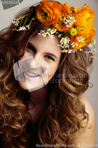 Image of Beauty young woman with flowers and make up close up, real sprin