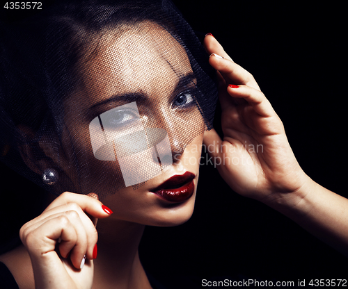 Image of beauty brunette woman under black veil with red manicure close u