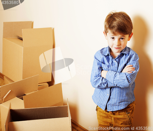 Image of little cute boy in empty room, remoove to new house. home alone,