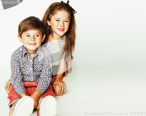 Image of little cute boy and girl hugging playing on white background, ha