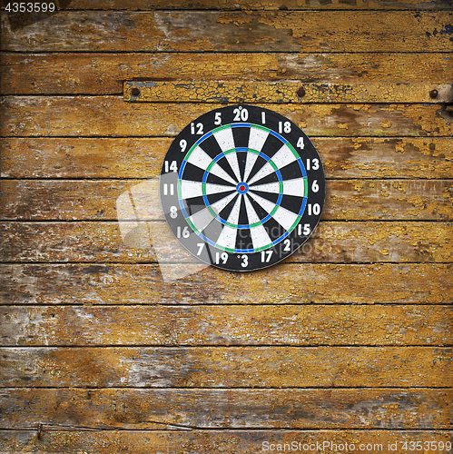 Image of Dart board on a wooden grunge wall