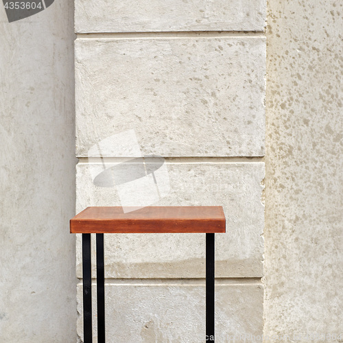 Image of outdoor table near the stucco wall