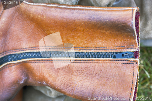 Image of Brown leather shoe, closeup metal zipper