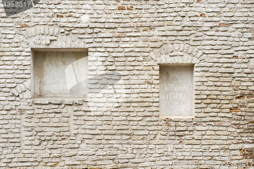 Image of abandoned cracked brick stucco wall with a stucco frame