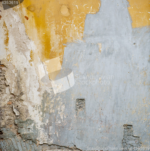 Image of colorful abandoned cracked brick stucco wall background
