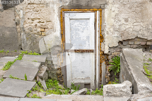 Image of wooden plank door, dirty grunge brick wall