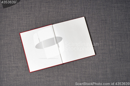 Image of Opened red book on the sofa