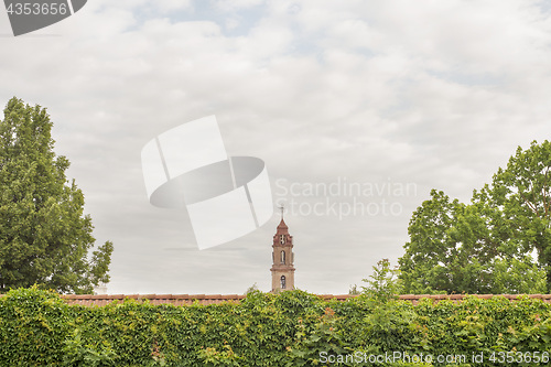 Image of church tower behind the red wall