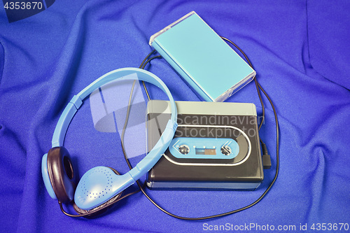 Image of Retro cassette walkman on the blue fabric background