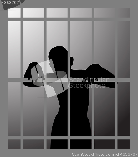 Image of Man in prison or dark dungeon behind bars