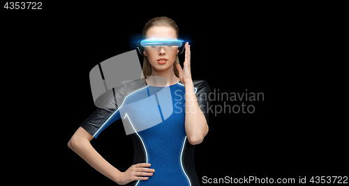 Image of woman in virtual reality 3d glasses over black