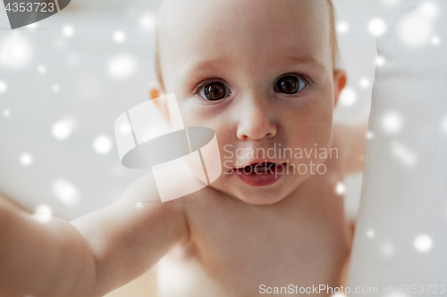 Image of close up of happy little baby over snow