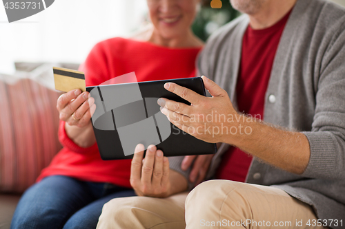 Image of senior couple with tablet pc shopping online