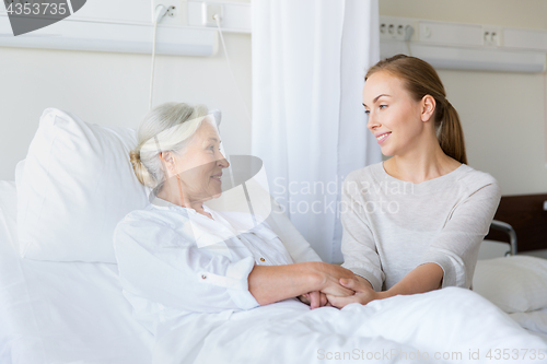 Image of daughter visiting senior mother at hospital