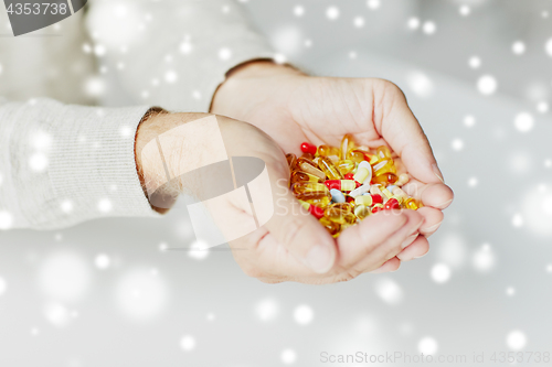 Image of close up of senior man hands holding pills