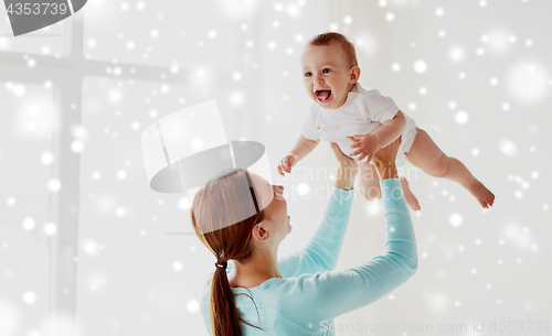 Image of happy young mother with little baby at home