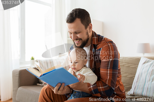 Image of happy father and little baby boy with book at home
