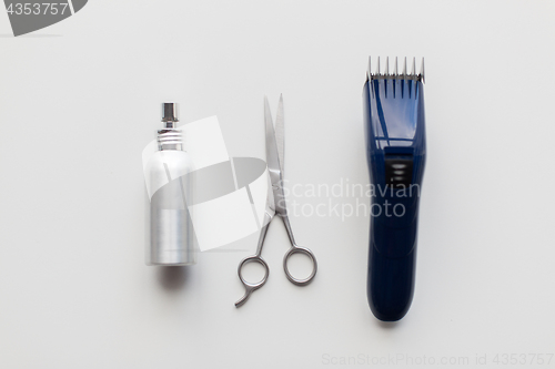 Image of styling hair spray, trimmer and scissors