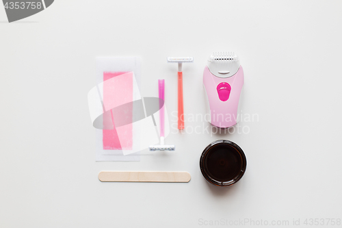 Image of hair removal wax, epilator and safety razor