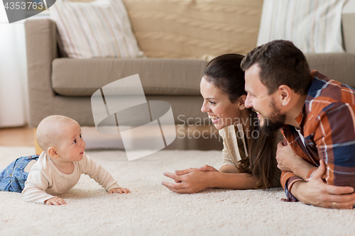 Image of happy family playing with baby at home