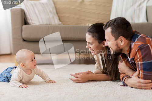 Image of happy family playing with baby at home