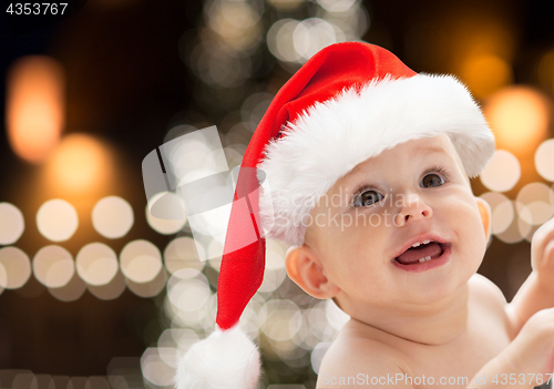 Image of close up of little baby in santa hat at christmas