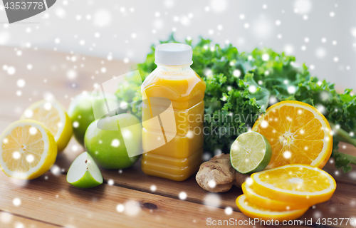 Image of bottle with orange juice, fruits and vegetables