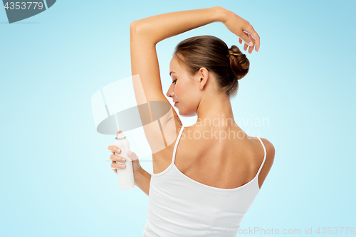 Image of woman with antiperspirant deodorant over white
