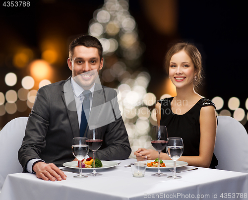 Image of couple at served restaurant table at christmas
