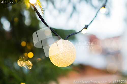 Image of close up of fir with christmas tree toys outdoors