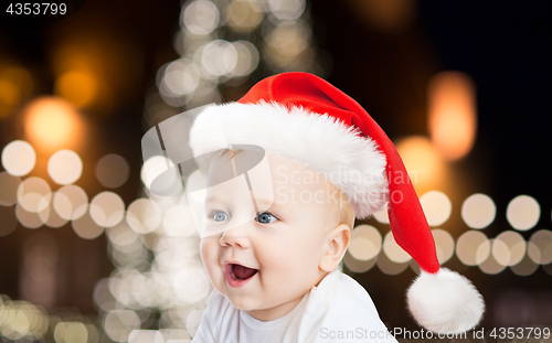 Image of little baby boy in santa hat at christmas