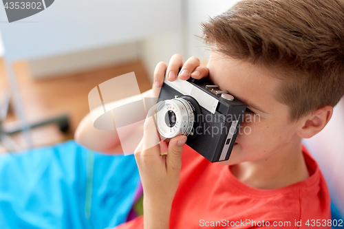 Image of close up of boy photographing by film camera