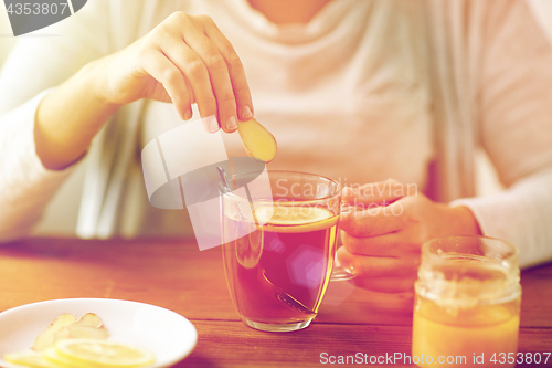 Image of close up of ill woman drinking tea with ginger