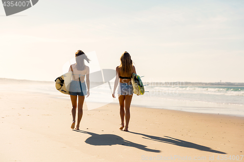 Image of Surfer girls walking on the beach