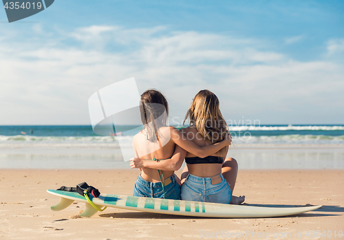 Image of Two surfer girls at the beach