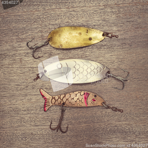 Image of Retro rusty lures on the wooden background