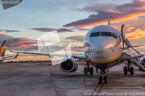 Image of Ryanair Jet commercial airplane on Valencia airport at sunset.