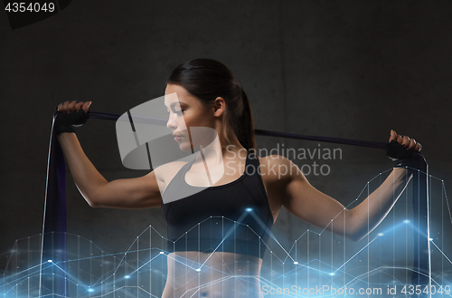 Image of woman with expander exercising in gym