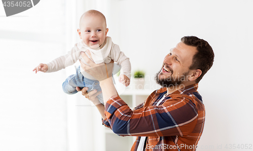 Image of happy father with little baby boy at home