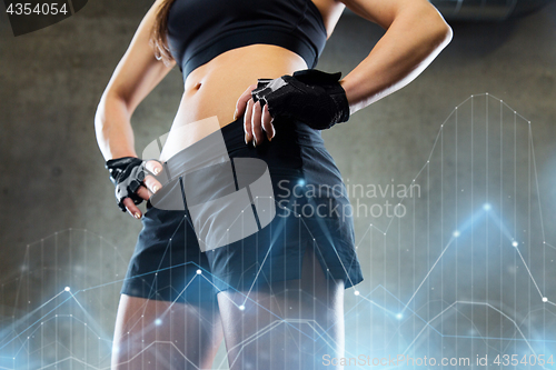 Image of young woman torso and hips in gym