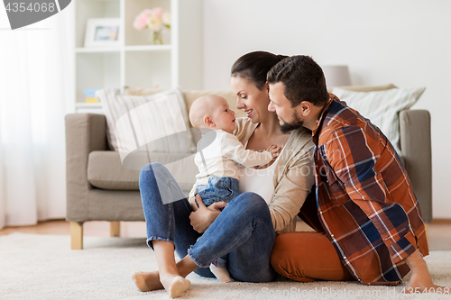 Image of happy family with baby having fun at home