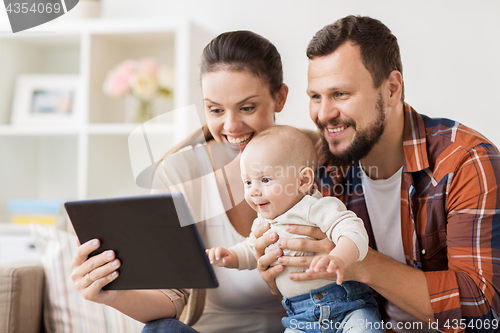 Image of mother, father and baby with tablet pc at home