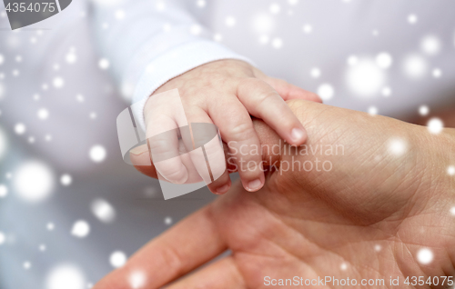 Image of close up of mother and newborn baby hands