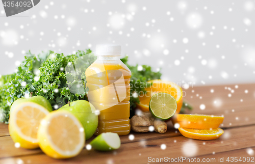 Image of bottle with orange juice, fruits and vegetables